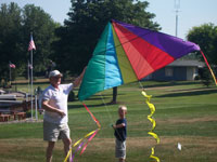 Manchester back pain free grandpa and grandson playing with a kite
