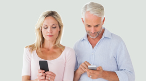 Manchester couple using smartphones